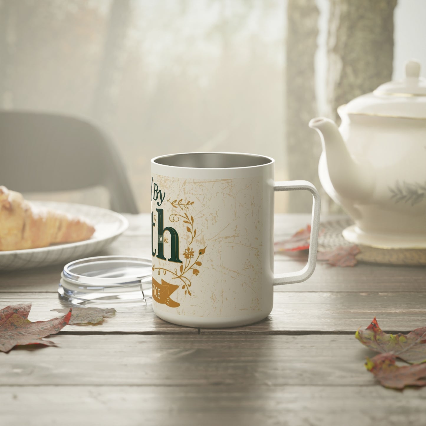 Fueled by Faith and Pumpkin Spice mug on wooden table with teapot — cozy fall morning scene featuring inspirational Christian drinkware.