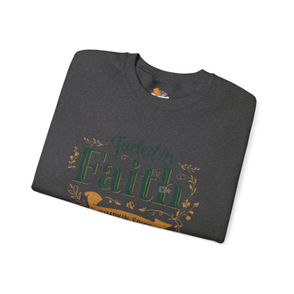 Folded dark heather “Fueled by Faith & Pumpkin Spice” sweatshirt with green and gold lettering — cozy autumn Christian apparel flat lay.