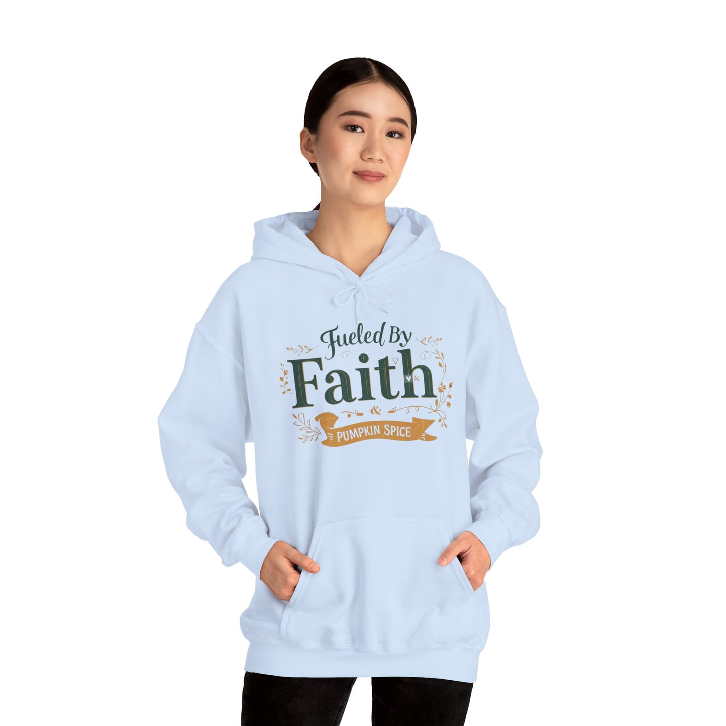 Woman wearing light blue “Fueled by Faith & Pumpkin Spice” hoodie — faith-inspired cozy fall fashion look.