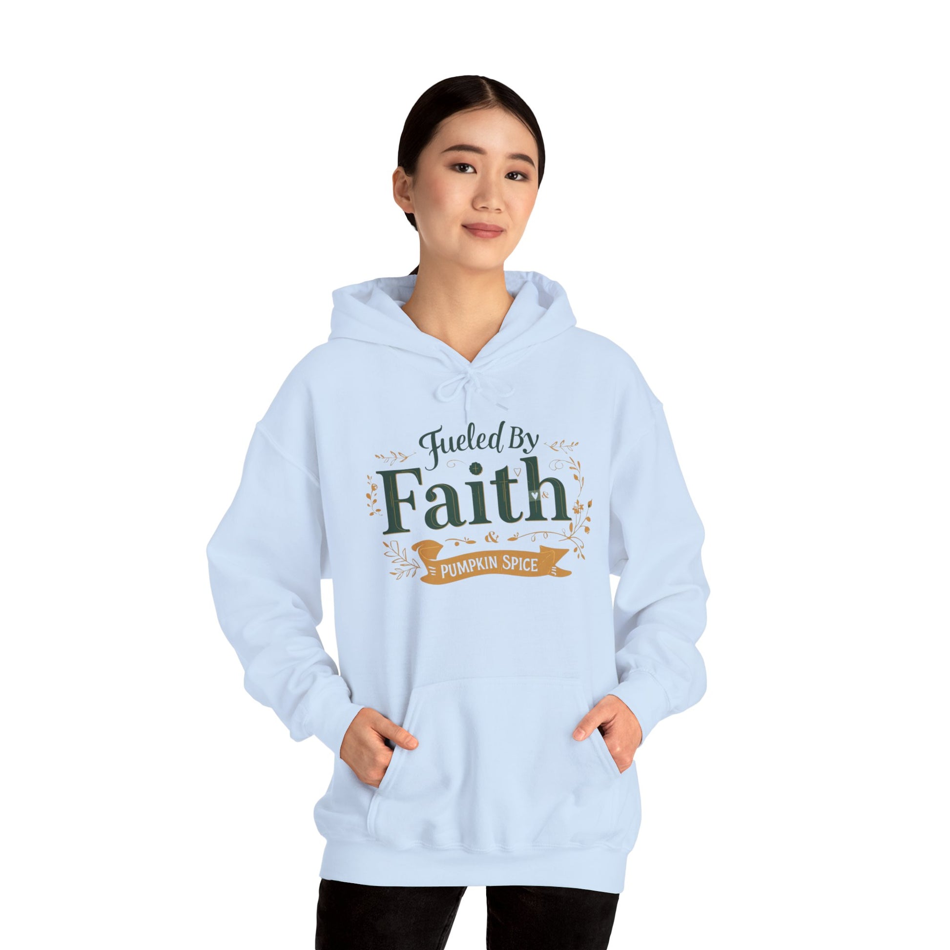 Woman wearing light blue “Fueled by Faith & Pumpkin Spice” hoodie — faith-inspired cozy fall fashion look.