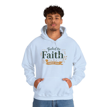 Man wearing light blue “Fueled by Faith & Pumpkin Spice” hoodie — unisex Christian hoodie perfect for the fall season.