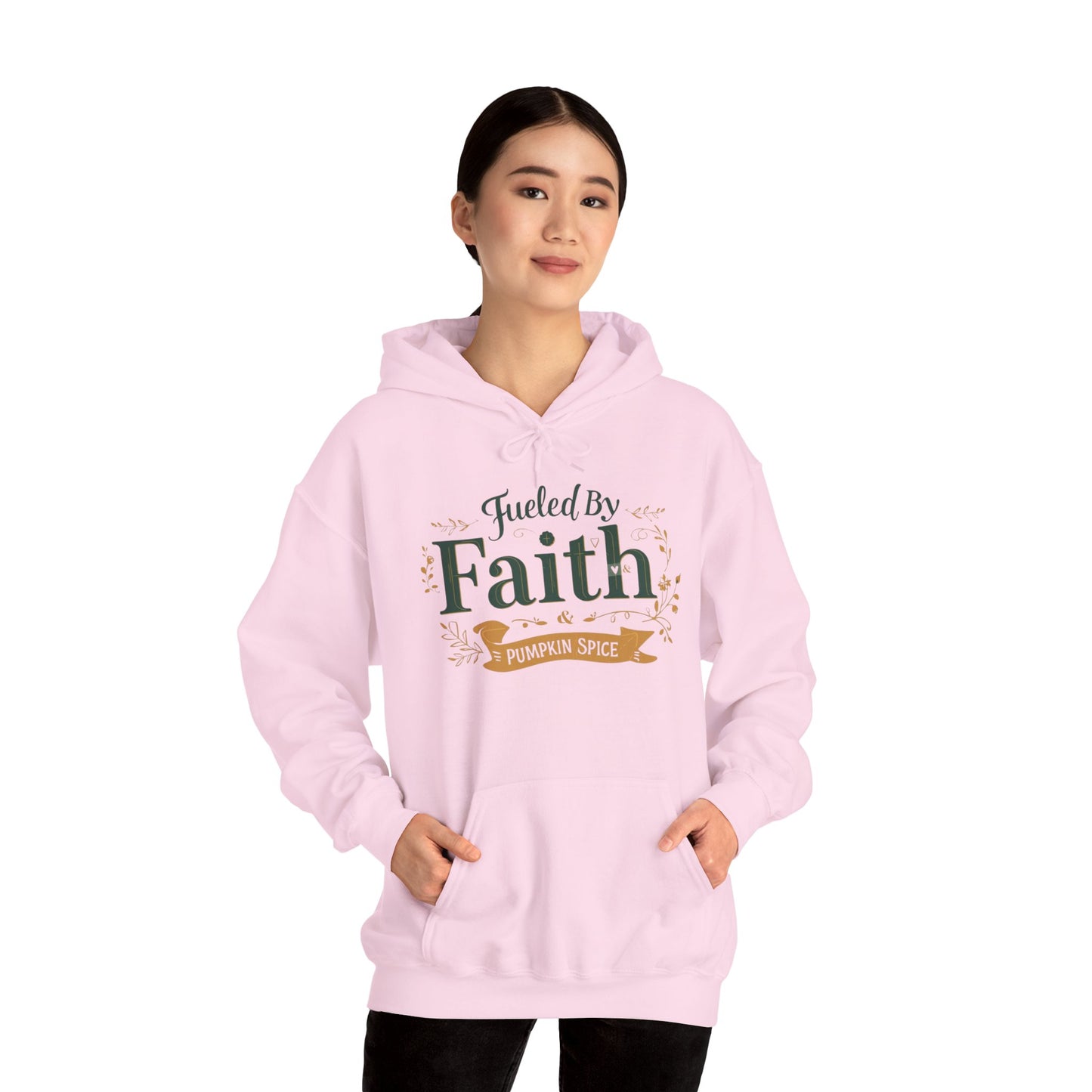Woman modeling pink “Fueled by Faith & Pumpkin Spice” hoodie — faith-inspired cozy fall hoodie with modern Christian style.