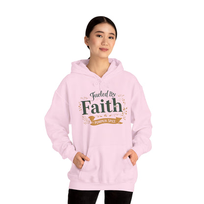 Woman modeling pink “Fueled by Faith & Pumpkin Spice” hoodie — faith-inspired cozy fall hoodie with modern Christian style.