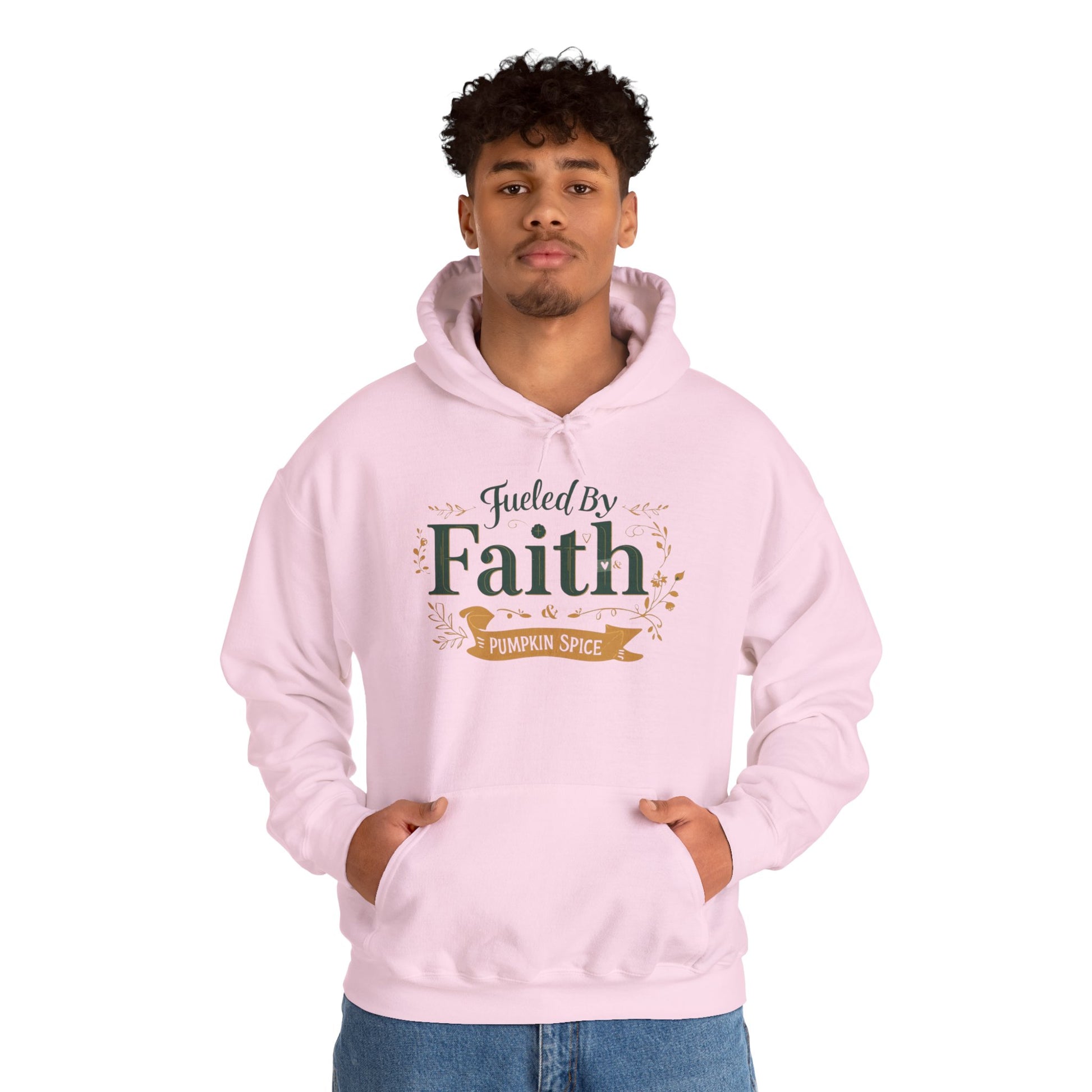 Man wearing pink “Fueled by Faith & Pumpkin Spice” hoodie — relaxed Christian fall outfit for believers.