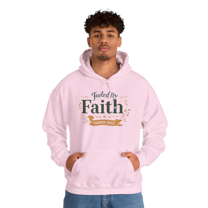 Man wearing pink “Fueled by Faith & Pumpkin Spice” hoodie — relaxed Christian fall outfit for believers.