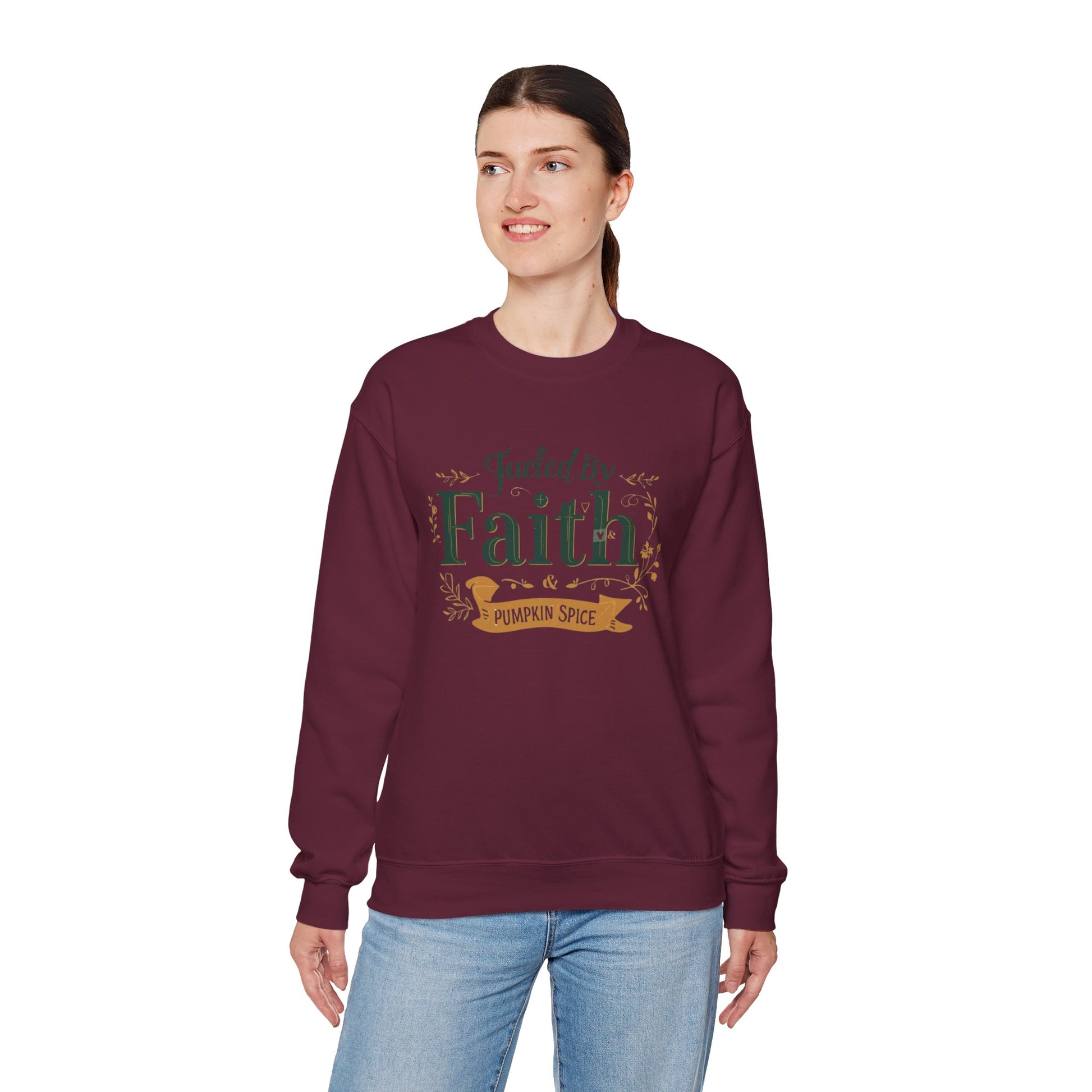 Woman modeling maroon “Fueled by Faith & Pumpkin Spice” crewneck sweatshirt — soft cozy unisex Christian fall outfit.