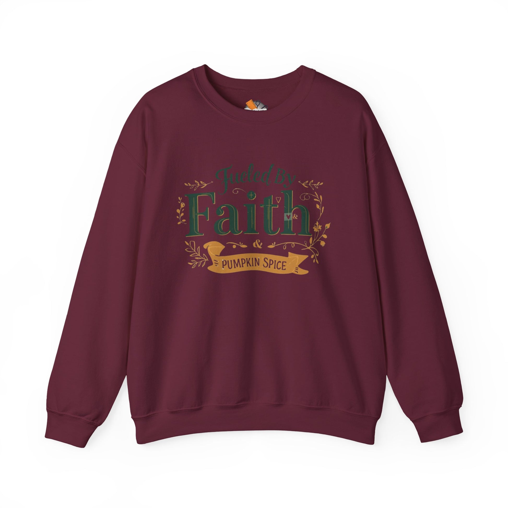 Maroon “Fueled by Faith & Pumpkin Spice” crewneck sweatshirt — cozy unisex Christian fall sweater with green and gold design.