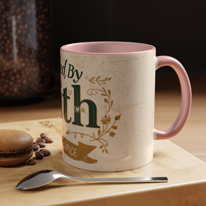 Lifestyle photo of pink “Fueled by Faith & Pumpkin Spice” 11oz mug — cozy Christian fall mug styled beside macarons, coffee beans, and a spoon.