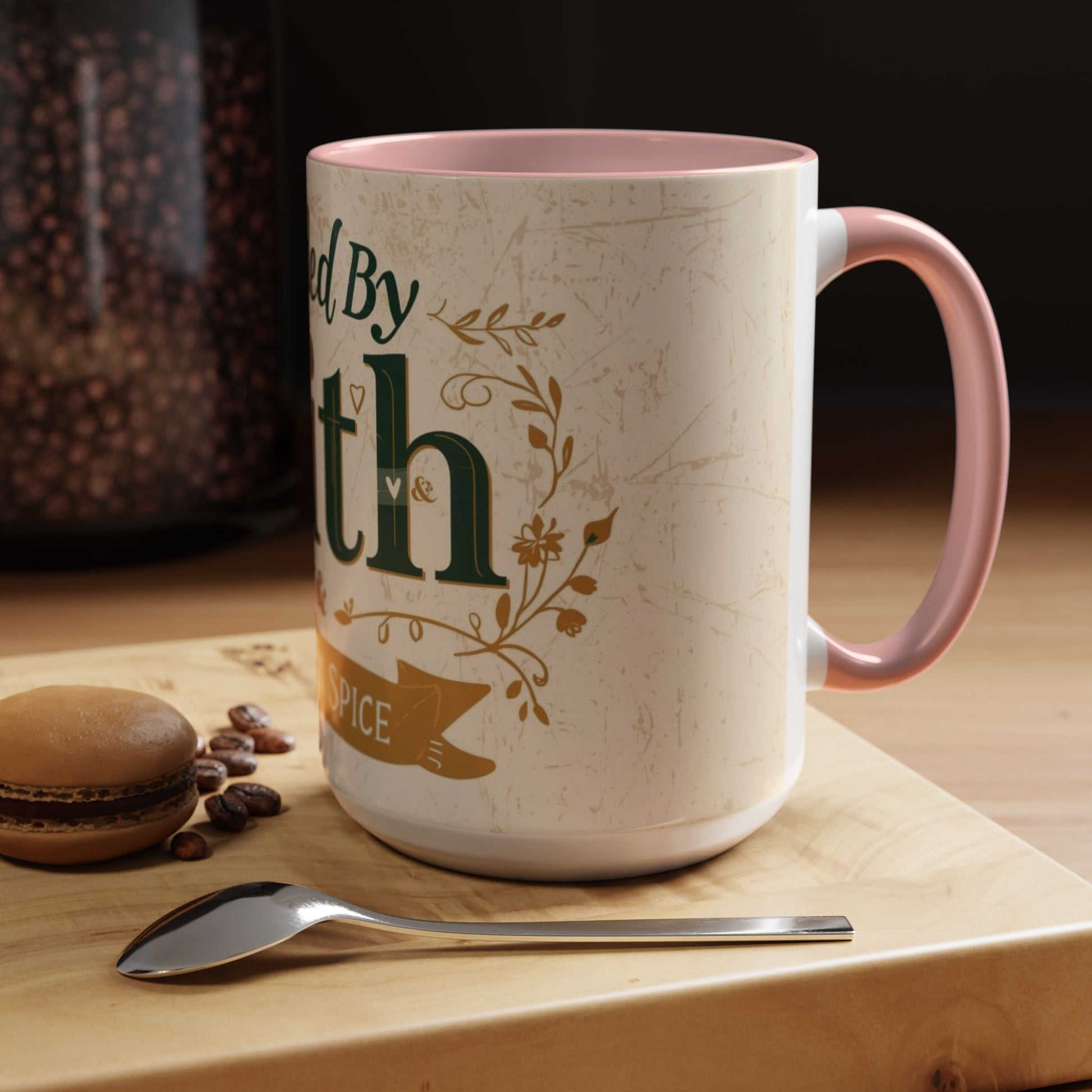 Lifestyle photo of pink “Fueled by Faith & Pumpkin Spice” 15oz accent mug — faith-inspired fall coffee cup with pink handle and cozy home aesthetic.