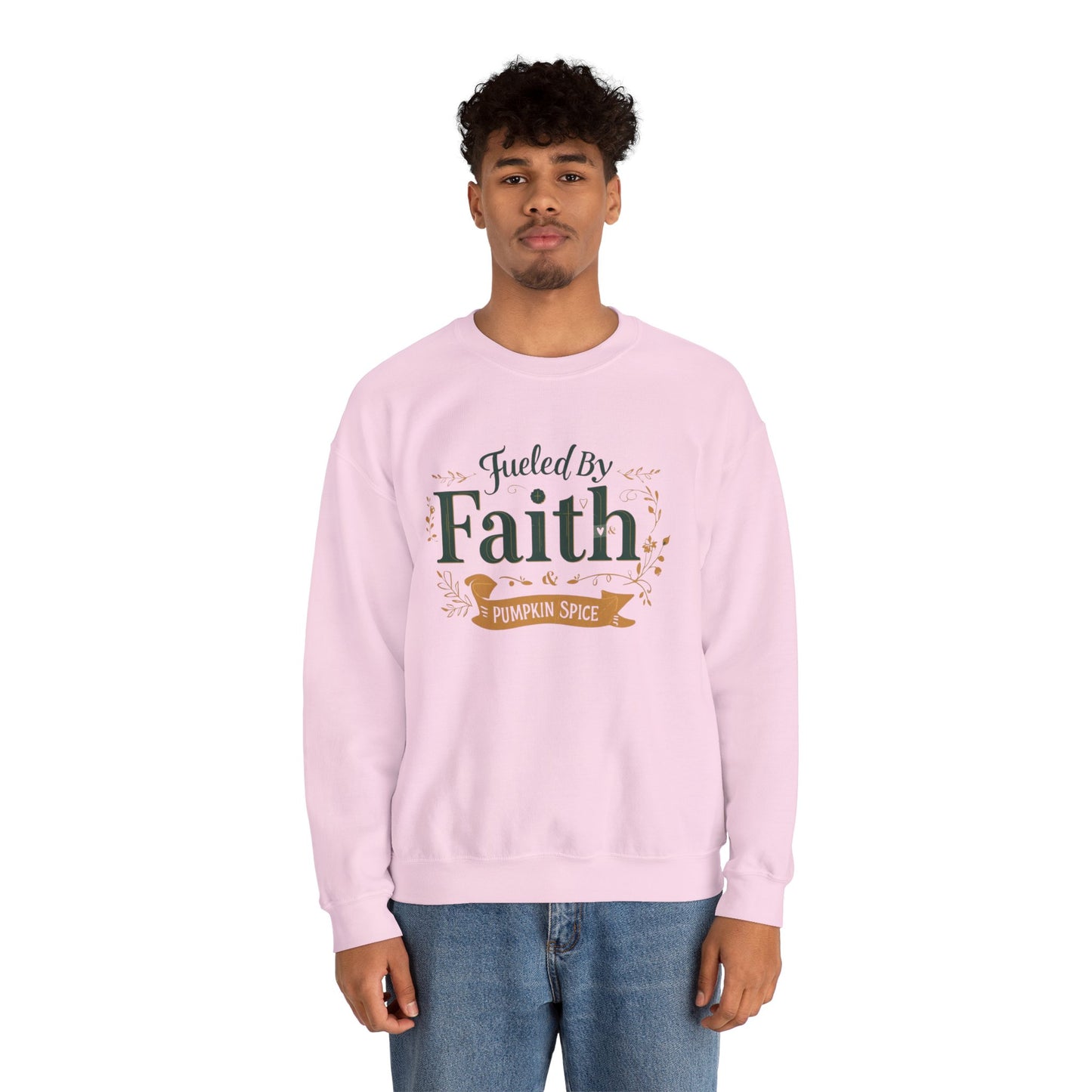 Man wearing light pink “Fueled by Faith & Pumpkin Spice” crewneck sweatshirt — casual unisex Christian fall outfit.