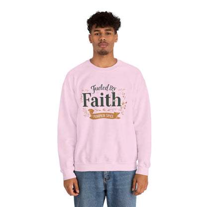 Man wearing light pink “Fueled by Faith & Pumpkin Spice” crewneck sweatshirt — casual unisex Christian fall outfit.