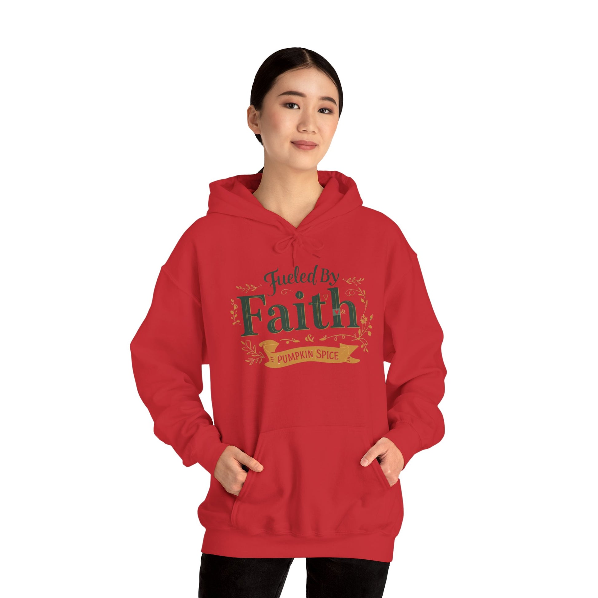 Woman modeling red “Fueled by Faith & Pumpkin Spice” hoodie — unisex Christian fall hoodie with faith-inspired design.