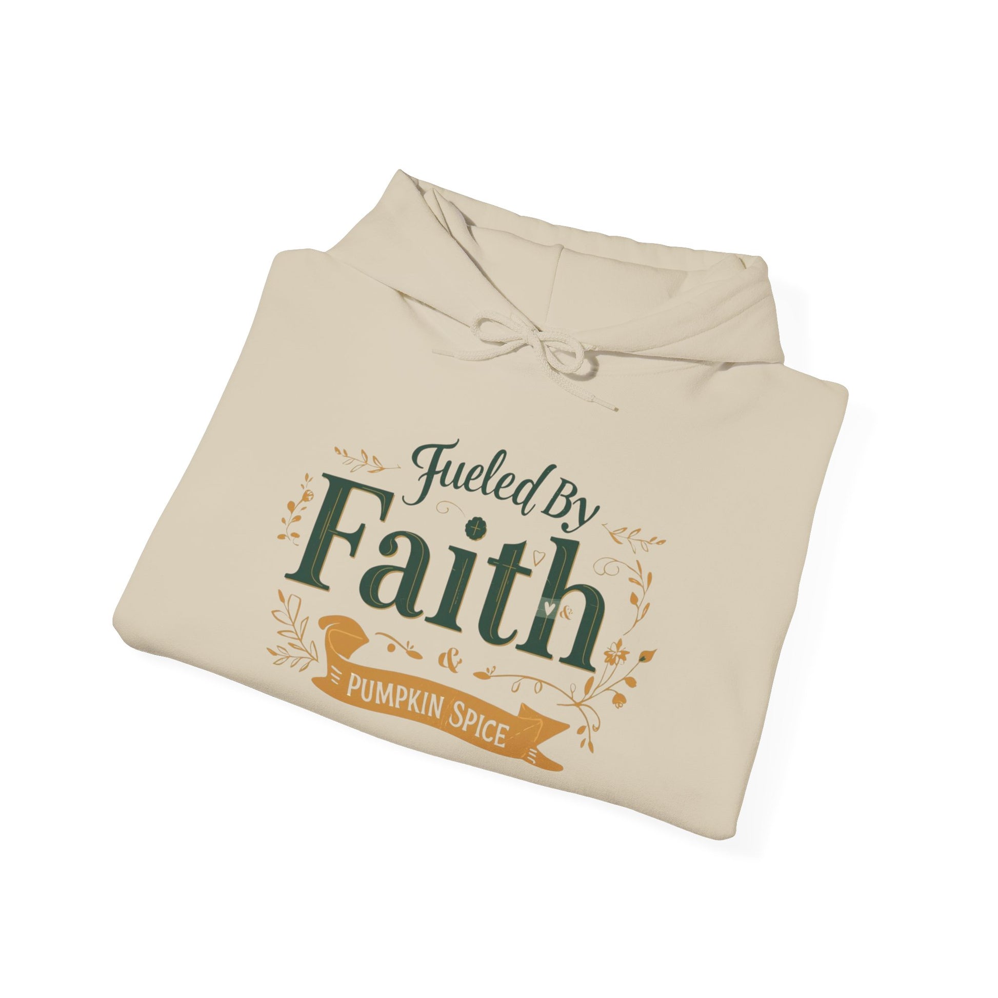 Folded sand “Fueled by Faith & Pumpkin Spice” hoodie — cozy Christian fall sweatshirt with gold and green typography.