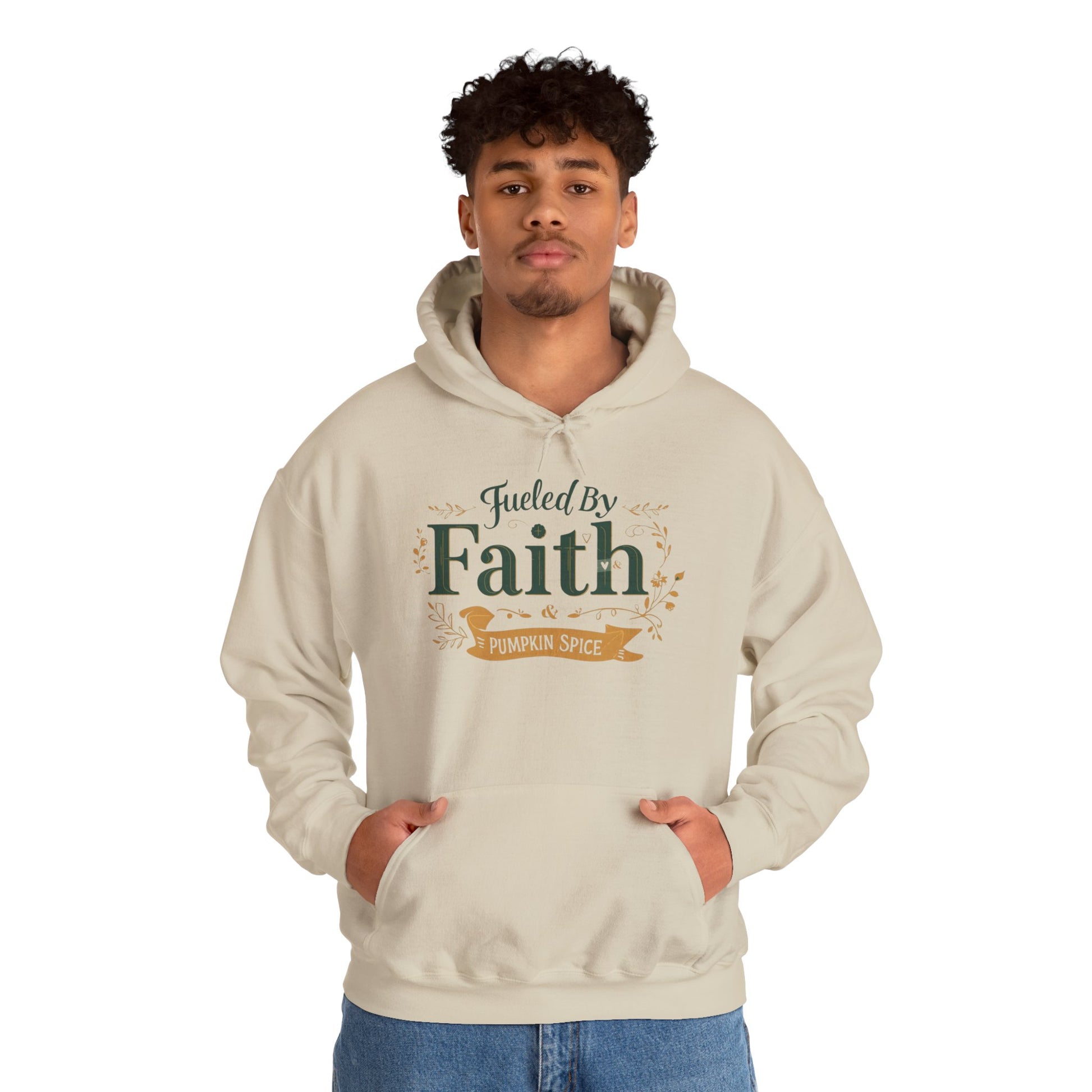 Man wearing sand “Fueled by Faith & Pumpkin Spice” hoodie — comfortable faith-inspired fall sweatshirt for believers.