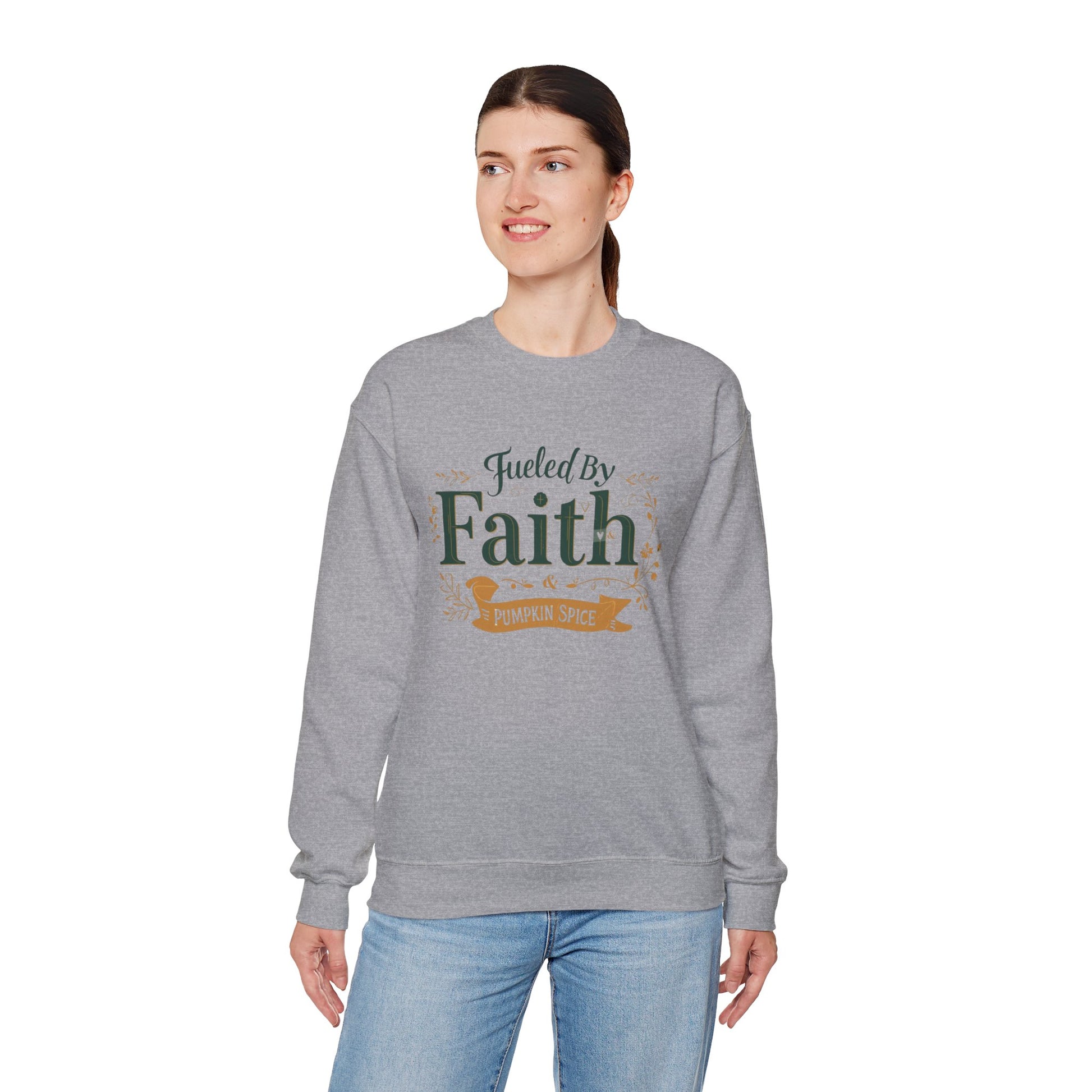 Woman modeling sport grey “Fueled by Faith & Pumpkin Spice” sweatshirt — comfortable unisex Christian fall sweater.
