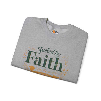 Folded sport grey “Fueled by Faith & Pumpkin Spice” sweatshirt with green and gold lettering — soft autumn Christian apparel flat lay.
