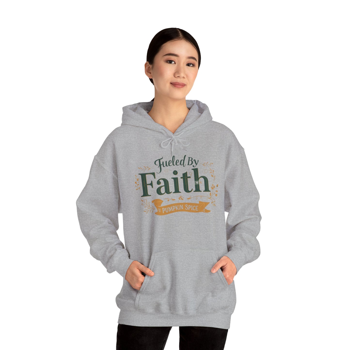 Woman wearing sport grey “Fueled by Faith & Pumpkin Spice” hoodie — cozy Christian fall fashion sweatshirt.