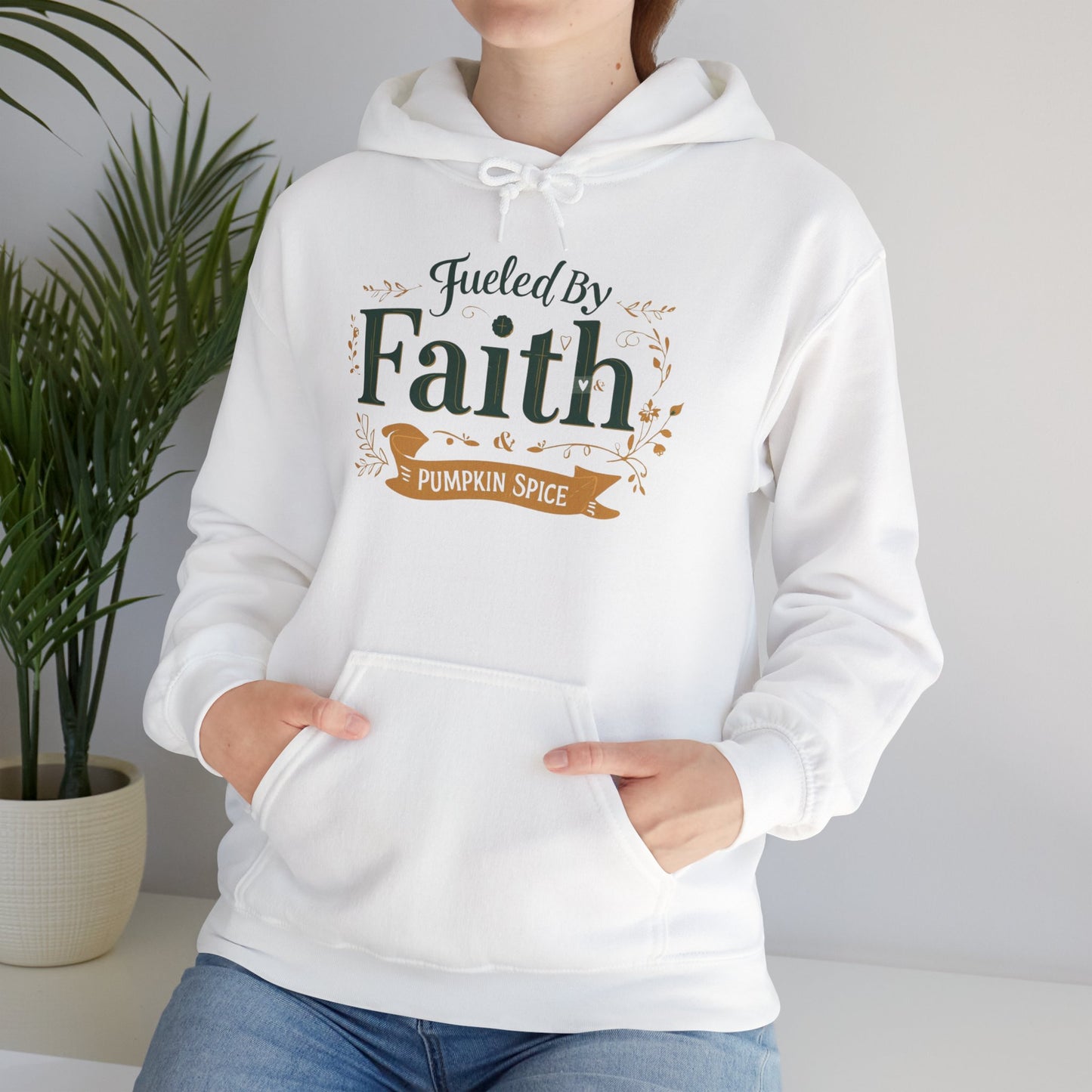 Lifestyle photo of woman wearing white “Fueled by Faith & Pumpkin Spice” hoodie — cozy Christian hoodie for believers and coffee lovers.