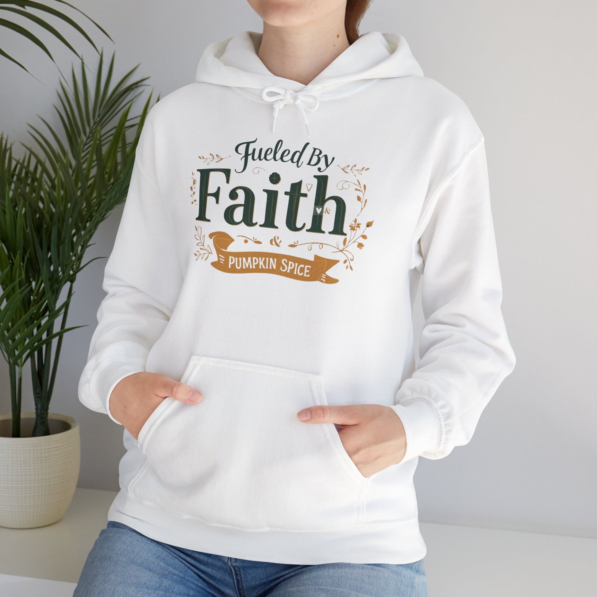 Lifestyle photo of woman wearing white “Fueled by Faith & Pumpkin Spice” hoodie — cozy Christian hoodie for believers and coffee lovers.