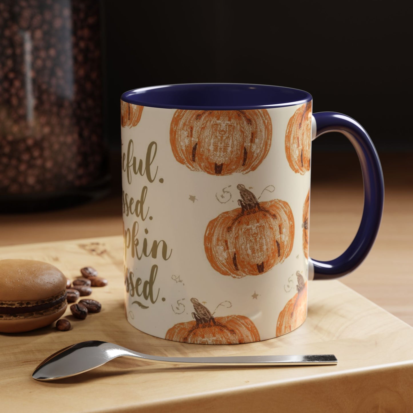 Grateful, Blessed & Pumpkin Obsessed navy accent mug styled on coffee table with macaron and beans — cozy autumn setup perfect for fall mornings.