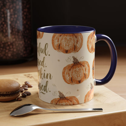 Grateful, Blessed & Pumpkin Obsessed navy accent mug styled on coffee table with macaron and beans — cozy autumn setup perfect for fall mornings.