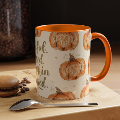 Grateful, Blessed & Pumpkin Obsessed orange accent mug styled on wooden table — cozy fall coffee setup with dessert, spoon, and warm morning light.