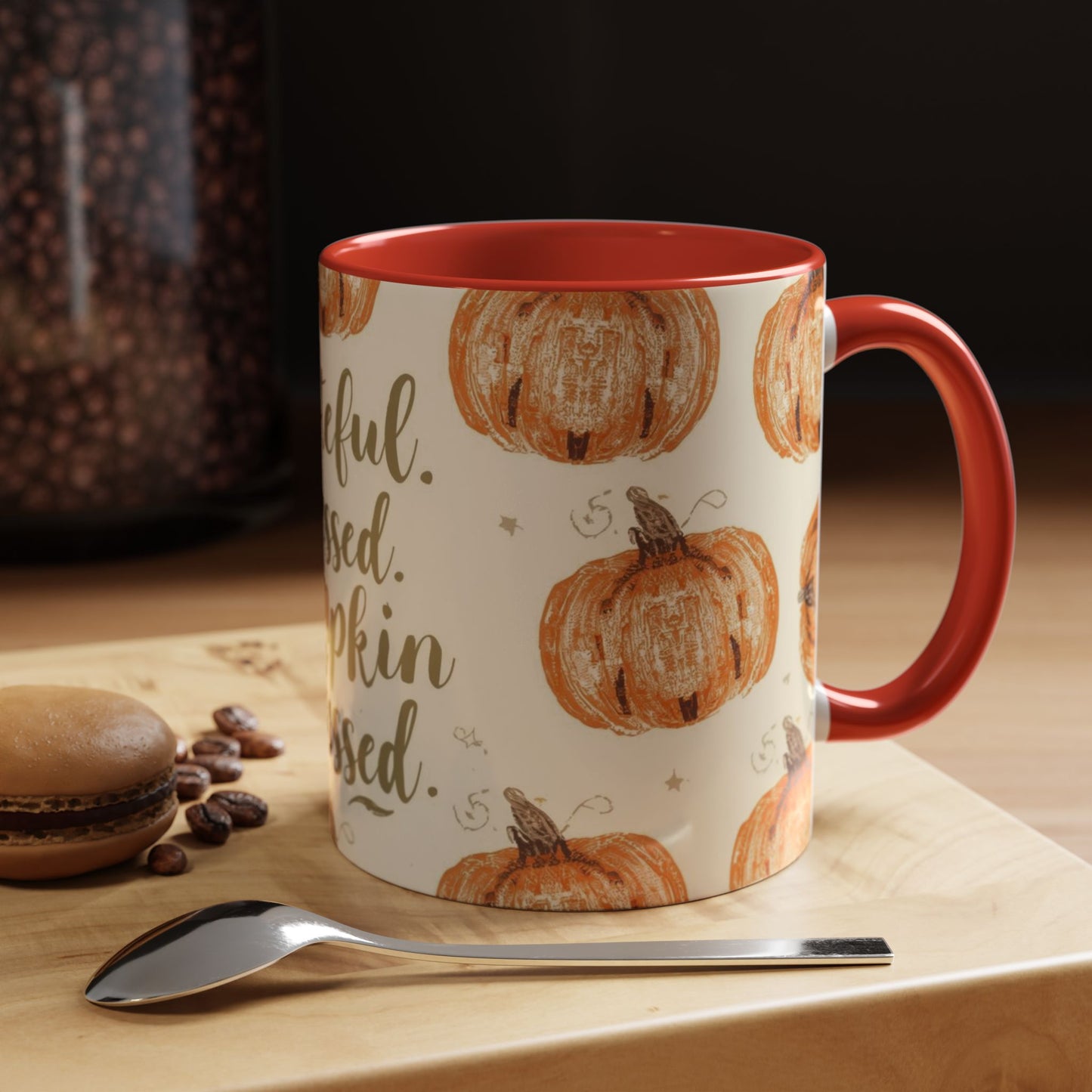 Grateful, Blessed & Pumpkin Obsessed red accent mug on cozy wooden table — fall drinkware with dessert and coffee beans in warm lighting.