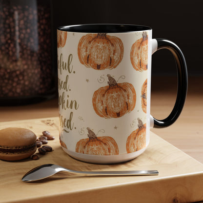 Grateful, Blessed & Pumpkin Obsessed black accent mug on wooden table beside macaron and coffee beans — cozy fall kitchen décor setup.