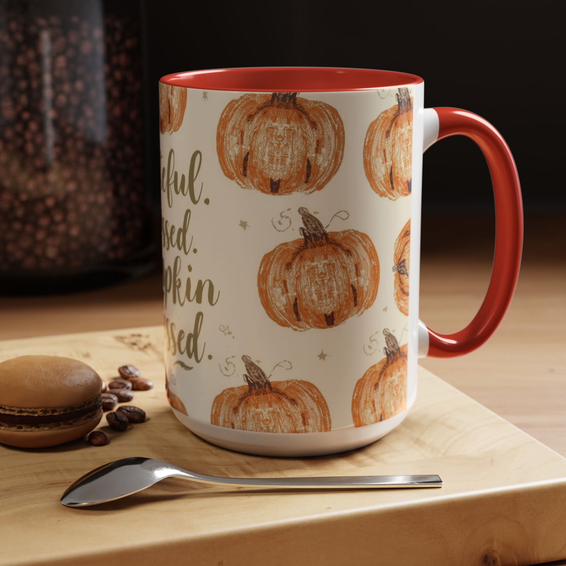 Grateful, Blessed & Pumpkin Obsessed red accent mug on cozy coffee table with macaron, beans, and spoon — perfect for pumpkin spice season.