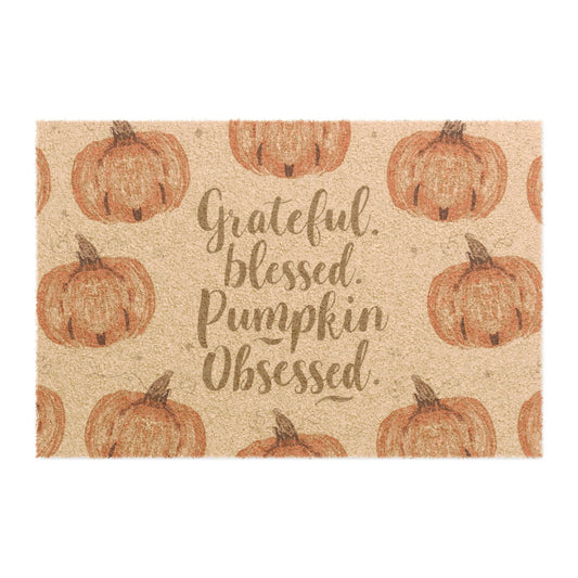 “Grateful, Blessed & Pumpkin Obsessed” fall doormat with orange pumpkins on tan background — cozy farmhouse welcome mat for autumn entryways.