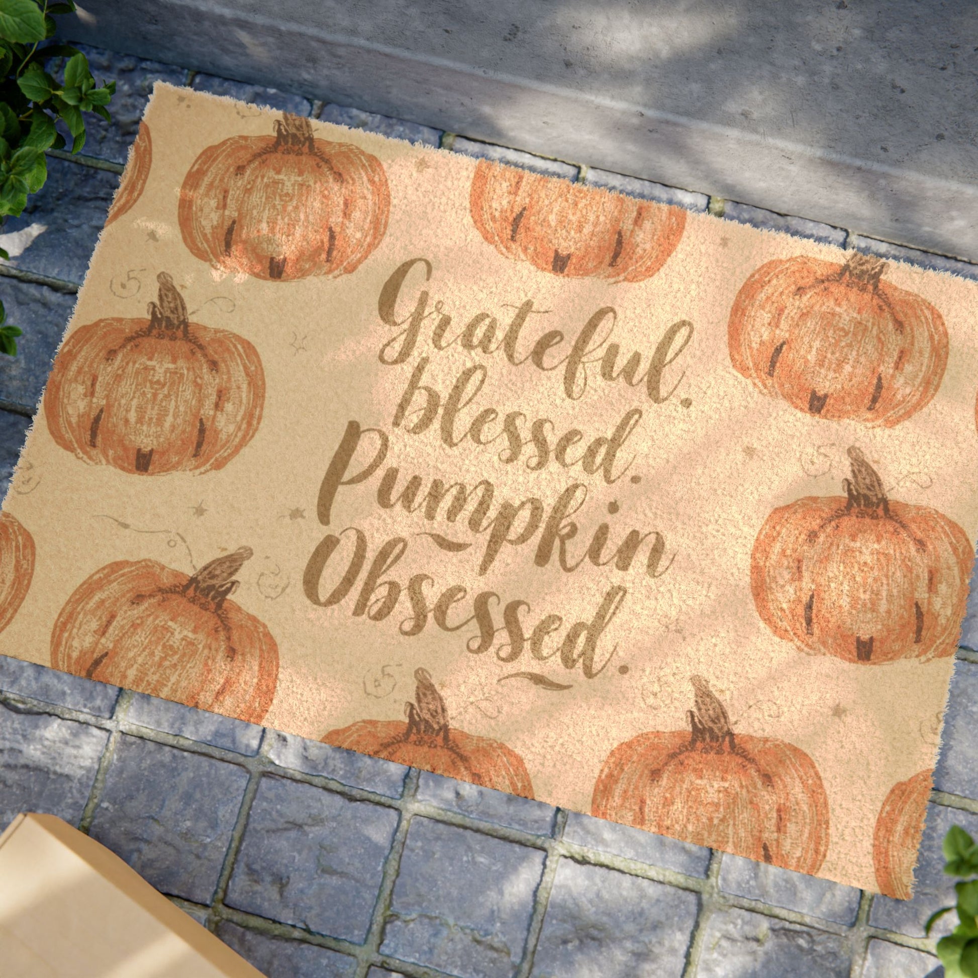 “Grateful, Blessed & Pumpkin Obsessed” fall doormat displayed outdoors — festive autumn welcome mat with rustic pumpkin design for cozy seasonal homes.