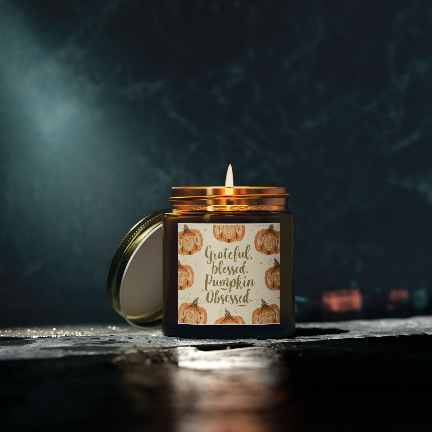 “Grateful, Blessed & Pumpkin Obsessed” amber candle glowing in dark room — relaxing lavender fragrance candle perfect for stress-relief evenings.