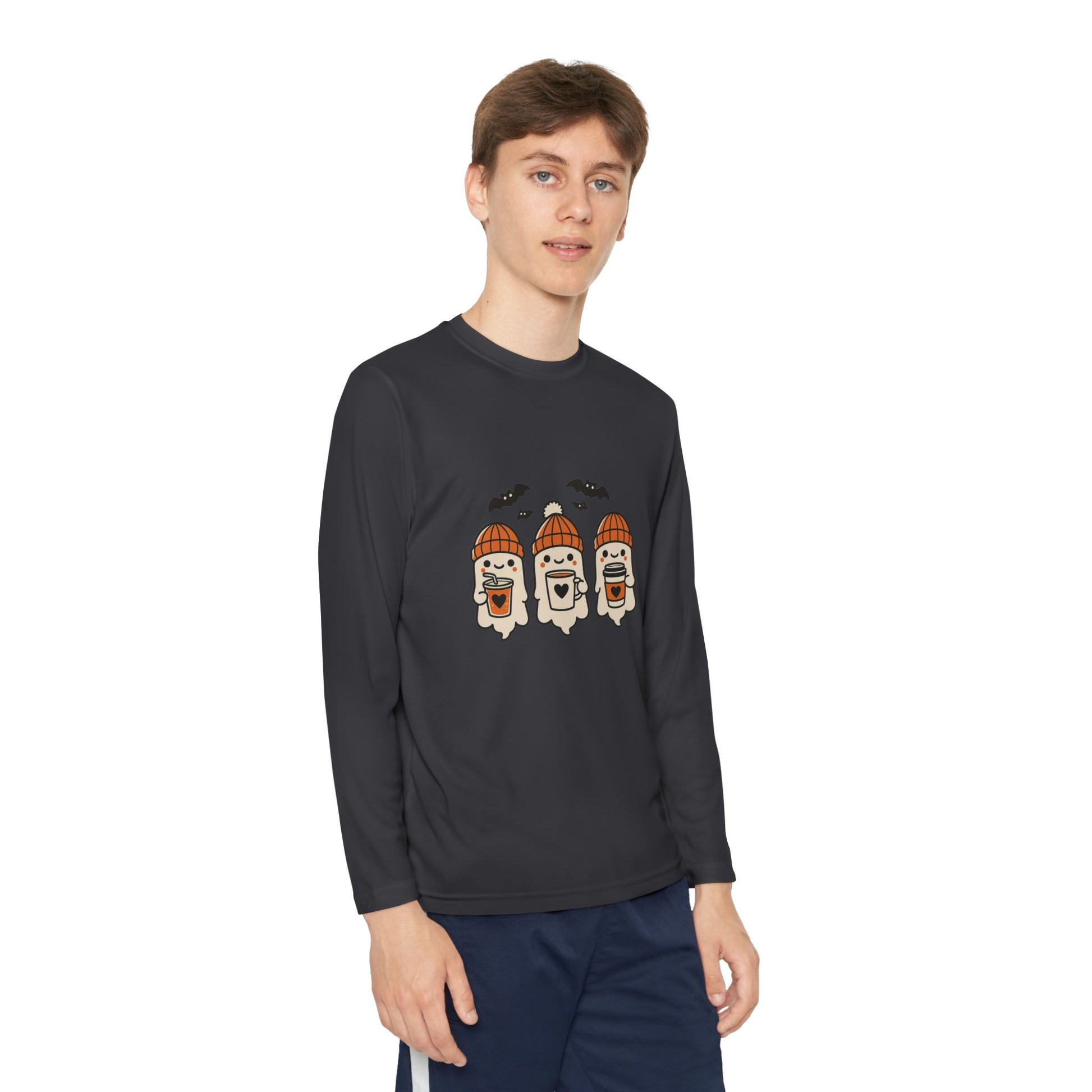 young/youth Man modeling charcoal grey long sleeve Halloween ghost shirt, cozy design by Makin’ It By Lady Ev.