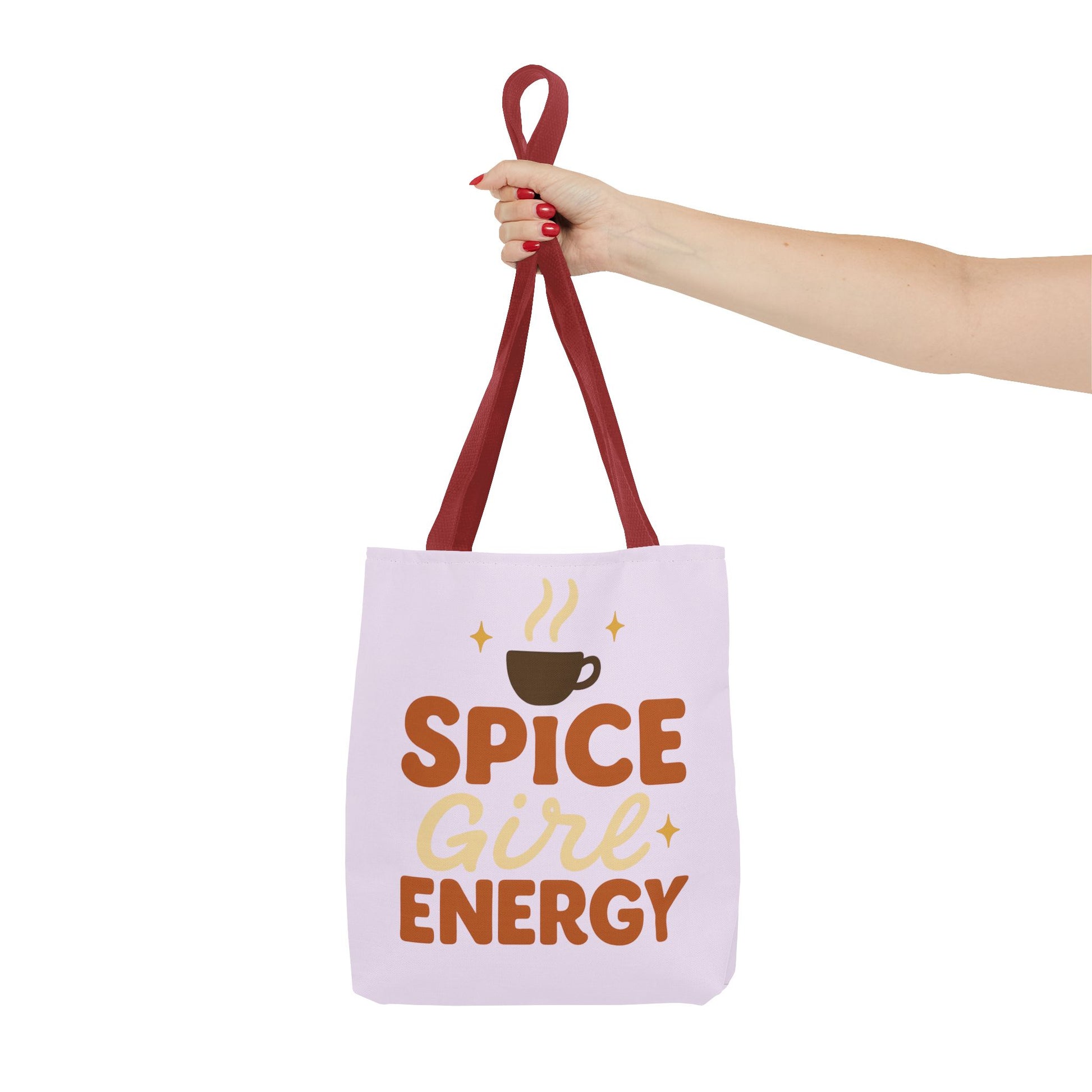 Red-handled lilac “Spice Girl Energy” tote bag held in hand — pink-purple pastel tote for coffee enthusiasts and autumn fashion lovers.