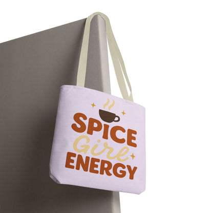 Lilac “Spice Girl Energy” tote bag with beige straps hanging on wall — trendy pastel tote bag for pumpkin spice and coffee enthusiasts.