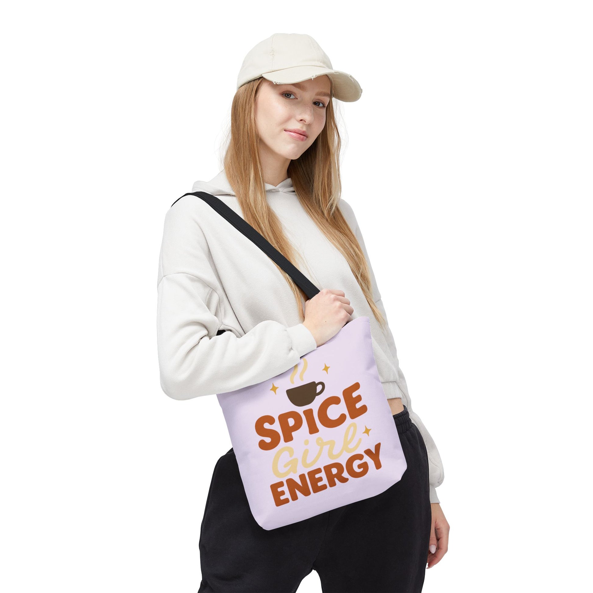 Woman wearing lilac “Spice Girl Energy” tote bag with black handles — chic pastel tote for cozy coffee runs and everyday errands.