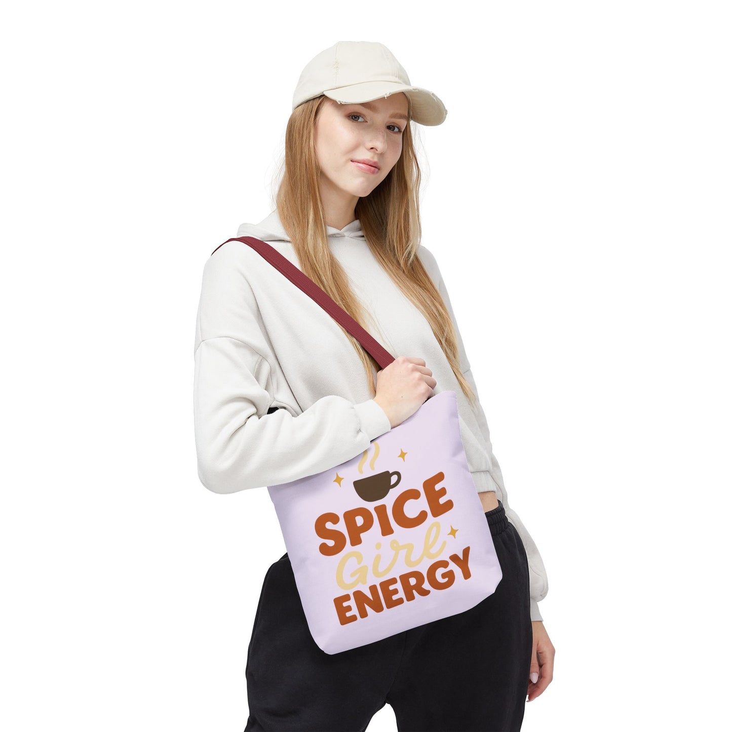 Woman carrying lilac “Spice Girl Energy” tote bag with red handles — cute pastel tote for cozy coffee runs and everyday style.