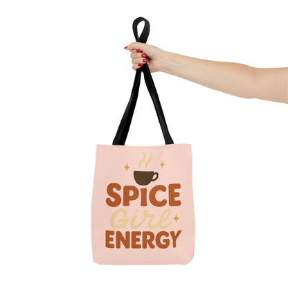 Pale pink “Spice Girl Energy” tote bag held by black handles — pastel coffee lover tote for fall fashion and daily errands.
