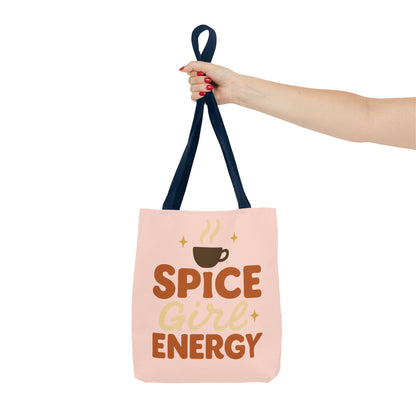 Navy-handled pale pink “Spice Girl Energy” tote bag held in hand — trendy pastel tote for coffee lovers and cozy fall fashion.