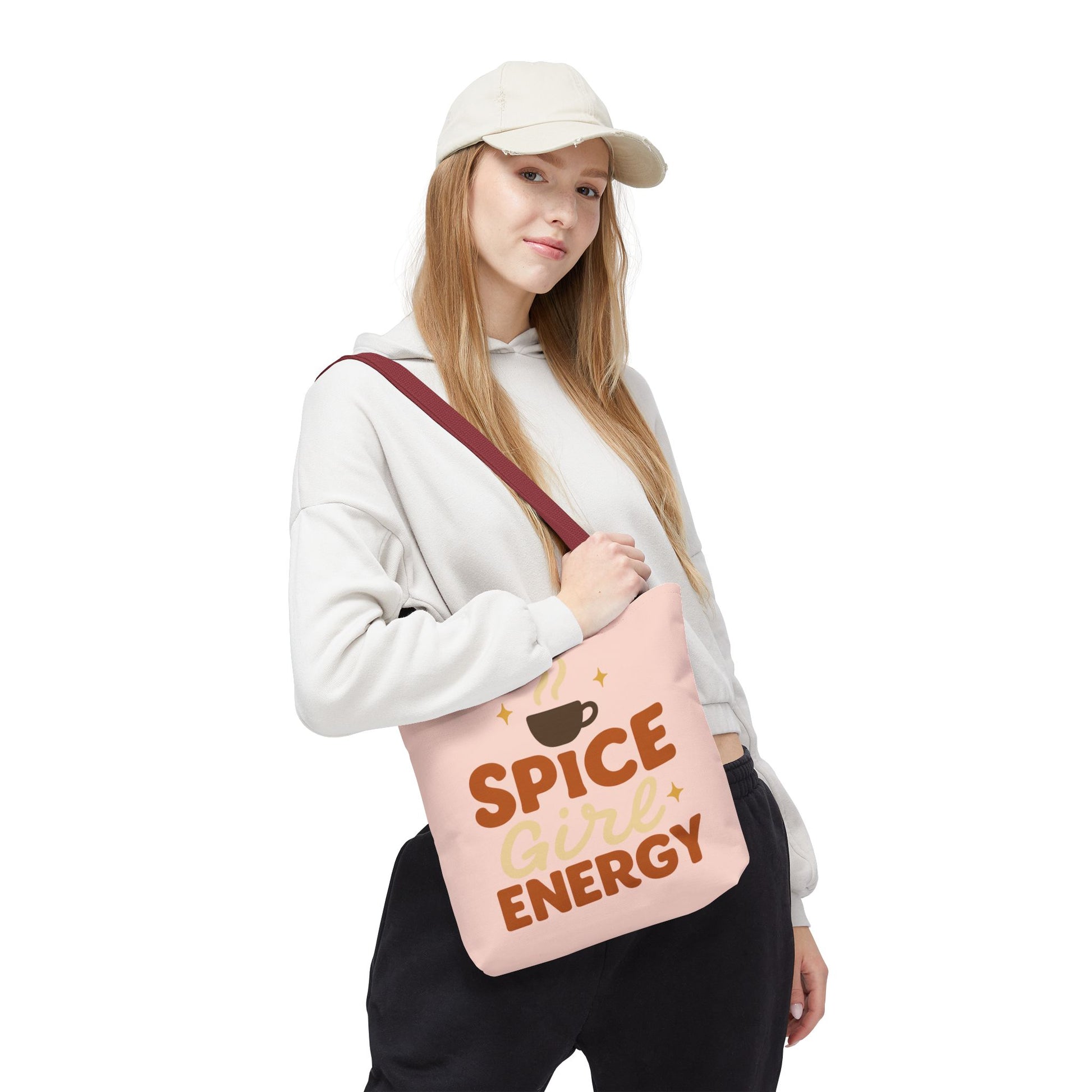 Woman wearing pale pink “Spice Girl Energy” tote bag with red handles — stylish pastel tote for fall fashion and everyday use.