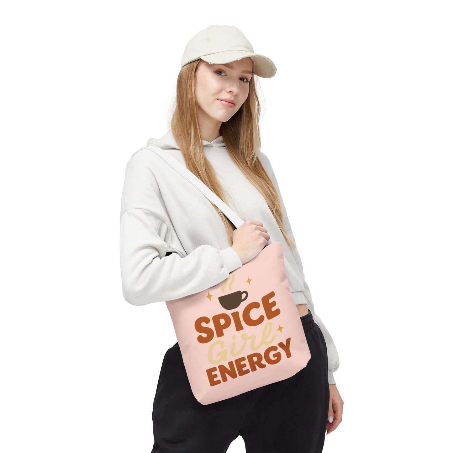 Model carrying pale pink “Spice Girl Energy” tote bag with white handles — pastel coffee tote for cozy days and autumn fashion.