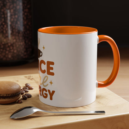 Orange “Spice Girl Energy” accent mug on wooden coffee table — white ceramic mug with orange interior beside spoon and macaron — cozy fall morning coffee scene.