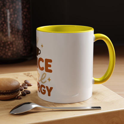 Yellow “Spice Girl Energy” accent mug on wooden coffee table — fall-inspired ceramic mug beside spoon and macaron, cozy morning scene.