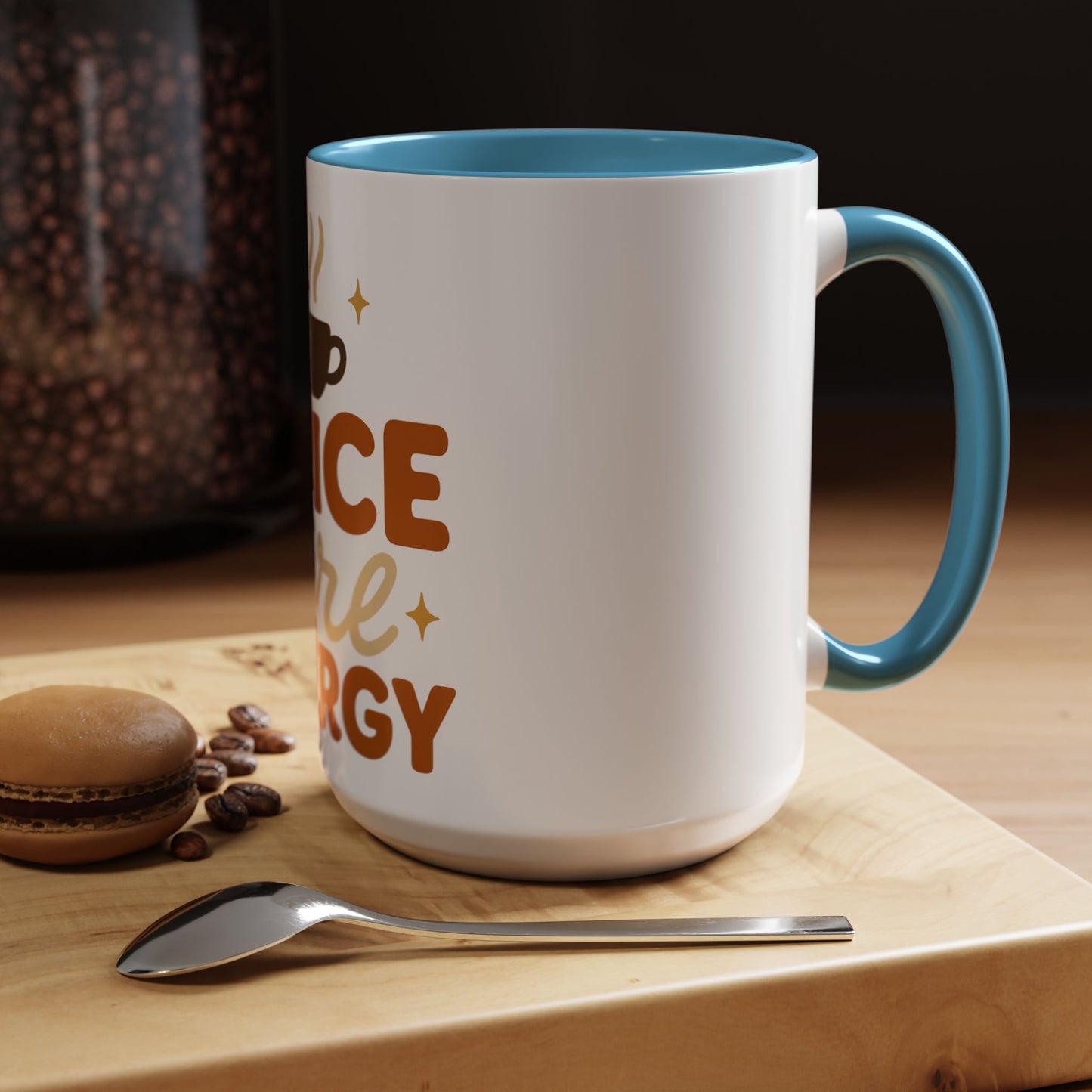 Light blue “Spice Girl Energy” accent mug on cozy wooden table — white ceramic 15 oz mug with blue handle beside coffee beans and macaron for fall aesthetic.