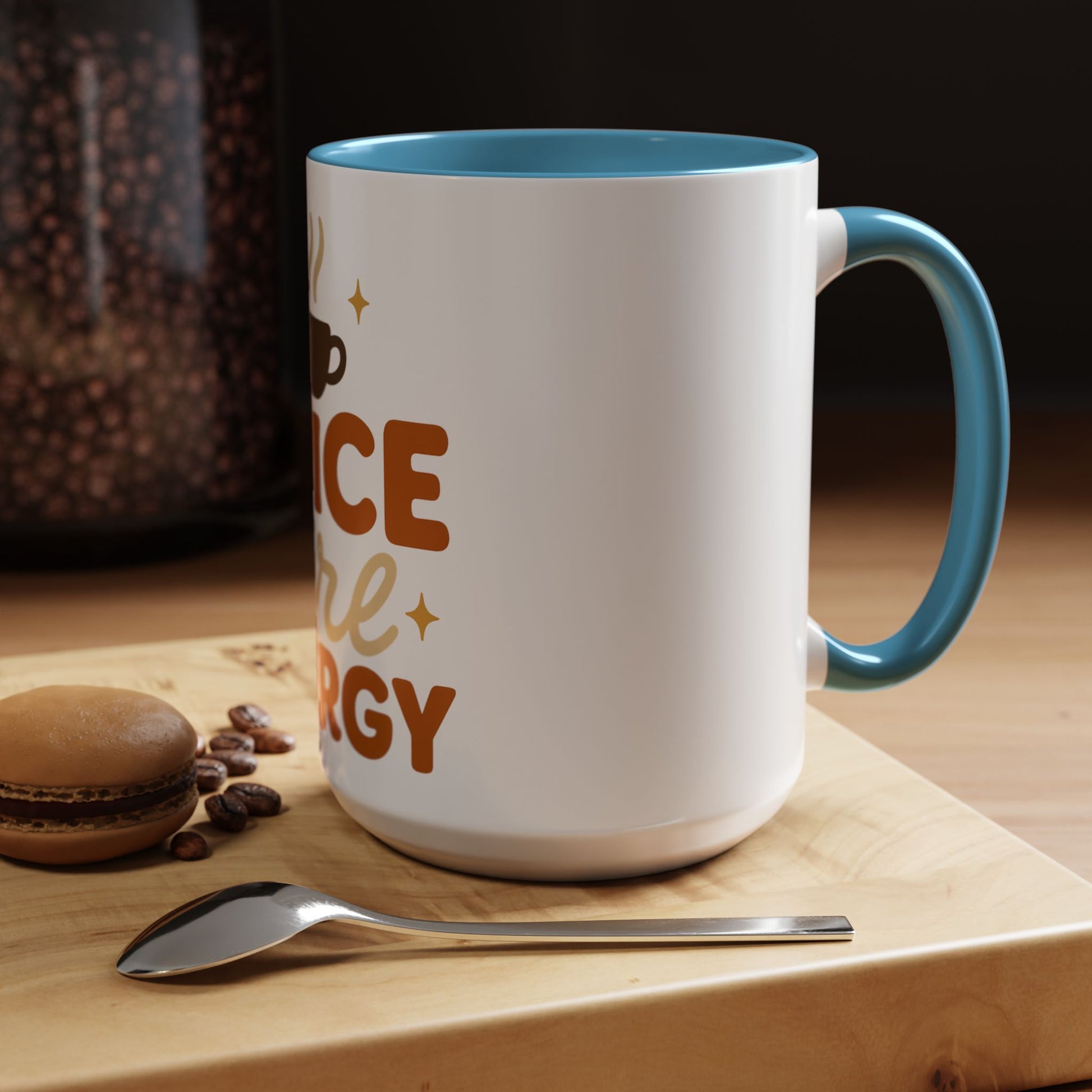 Light blue “Spice Girl Energy” accent mug on cozy wooden table — white ceramic 15 oz mug with blue handle beside coffee beans and macaron for fall aesthetic.