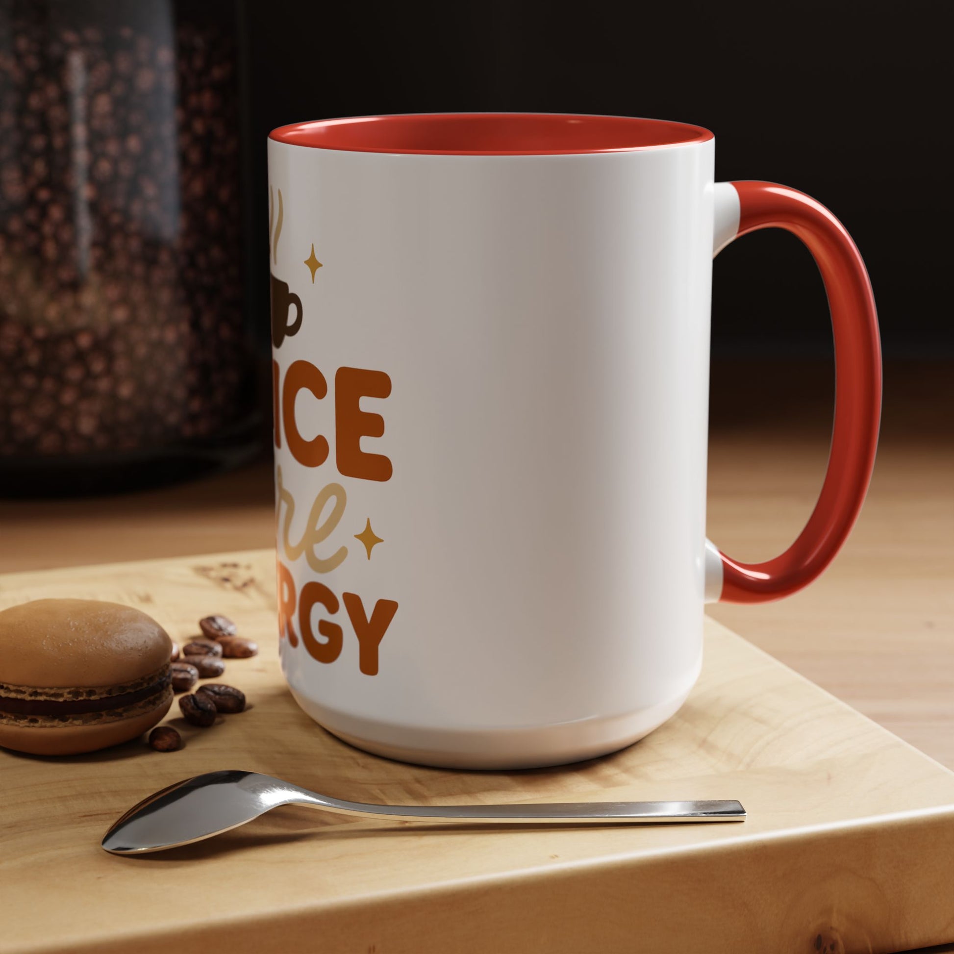 Red “Spice Girl Energy” accent mug on wooden coffee table — white ceramic 15 oz mug with red interior beside spoon and macaron, warm cozy scene.