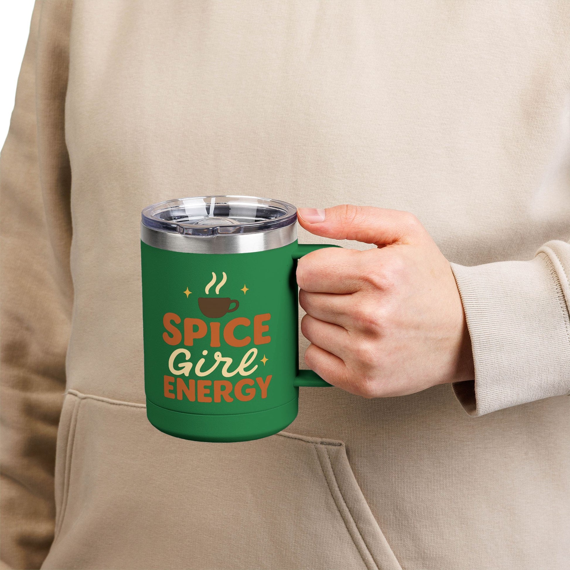 Person holding green “Spice Girl Energy” insulated mug — cozy reusable coffee mug for pumpkin spice and latte lovers.