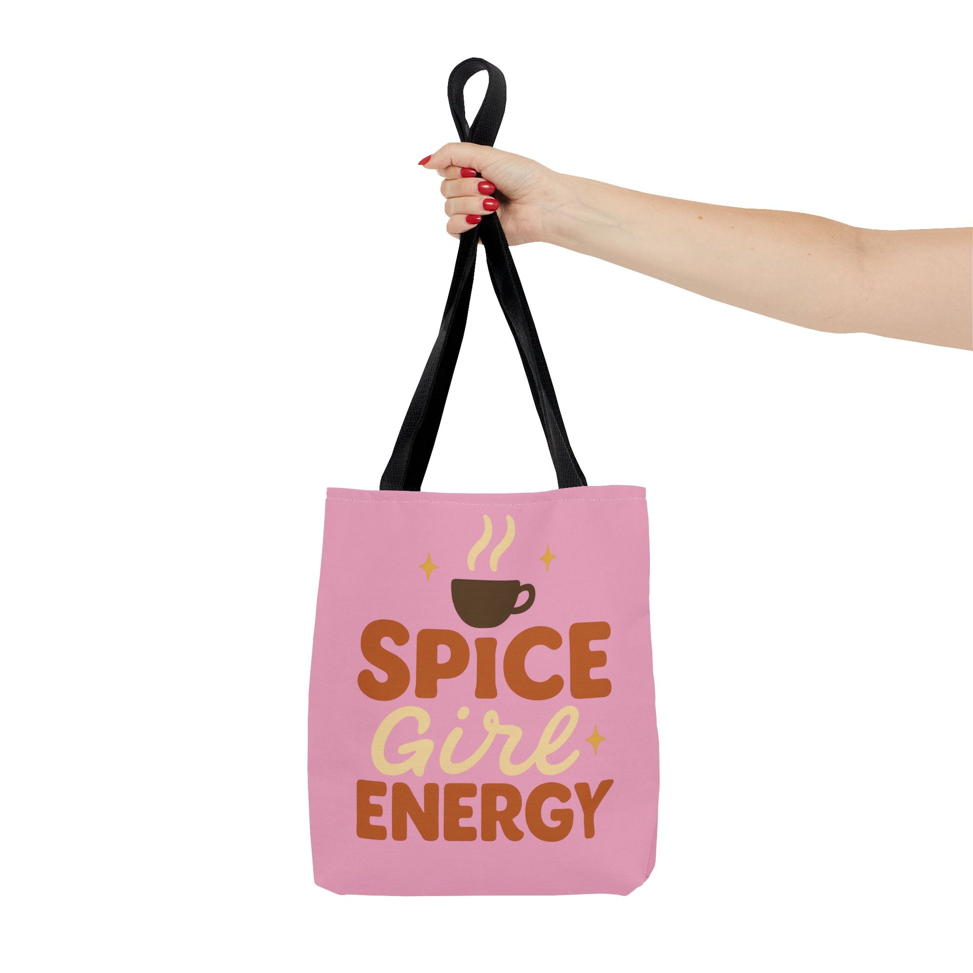 Black-handled “Spice Girl Energy” tote bag held in hand — stylish pink tote bag for coffee lovers and cozy fall fashion.