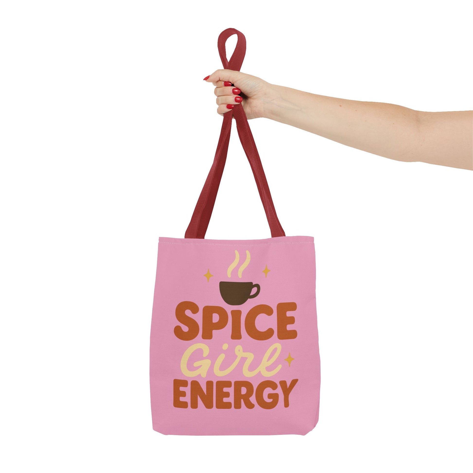 Red-handled “Spice Girl Energy” tote bag held in hand — pink motivational tote perfect for coffee enthusiasts and fall fashion lovers.