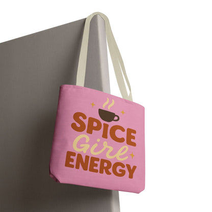 “Spice Girl Energy” tote bag with beige straps hanging on wall — pink fall tote with coffee cup graphic and cozy aesthetic.